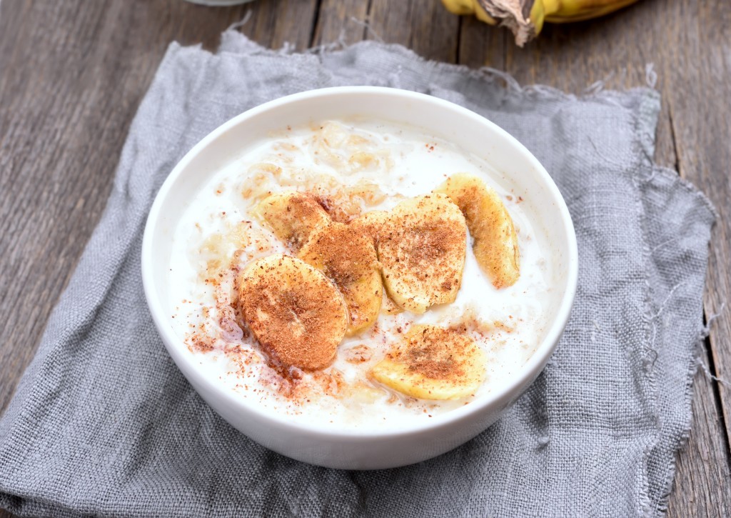 Porridge mit Gerstenflocken garniert mit Bananenscheiben und Zimt in weißer Schale. Oben rechts das Inform Logo.