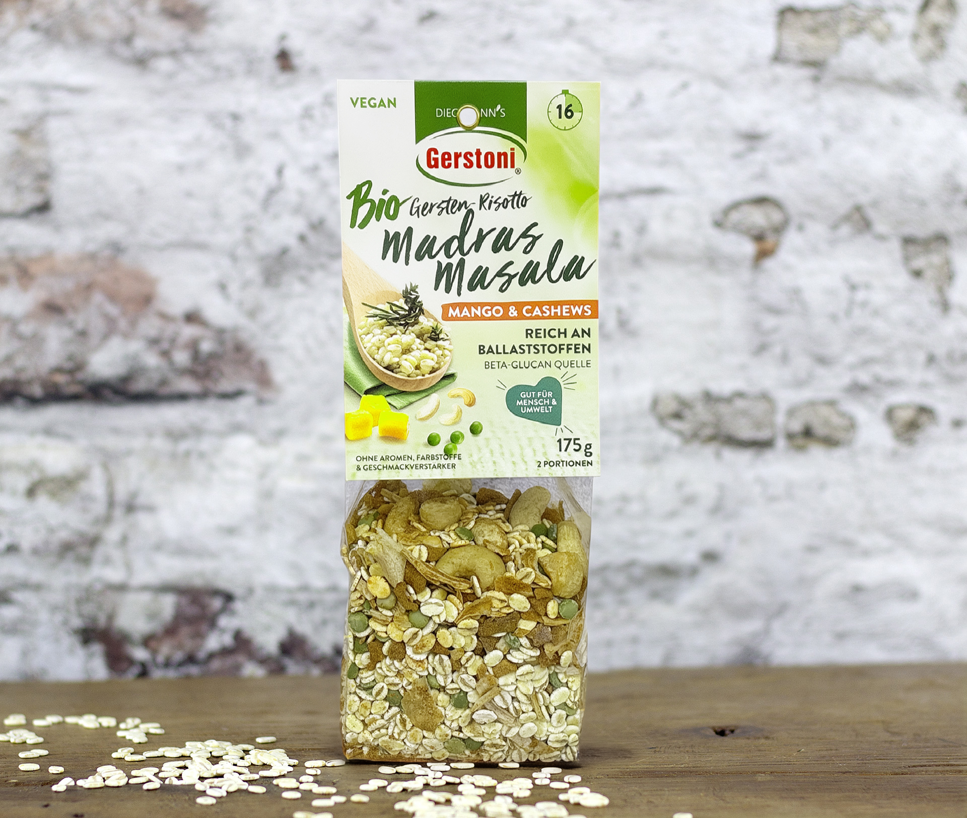 1er Packung Gerstoni Bio Madras Masala Risotto auf Holztisch vor einer weißen Backsteinmauer